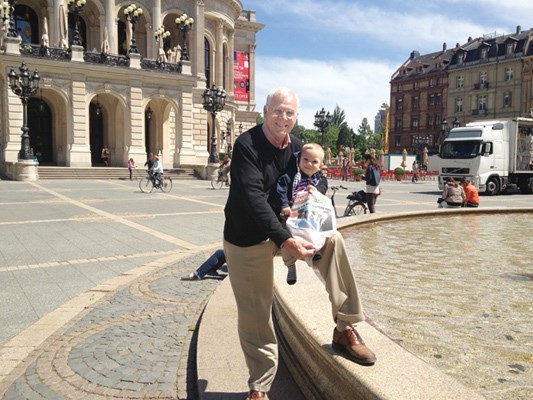 Andrew Morton and his 10-month-old grandson Jack take the North Shore News to the original opera house in Frankfurt, Germany.