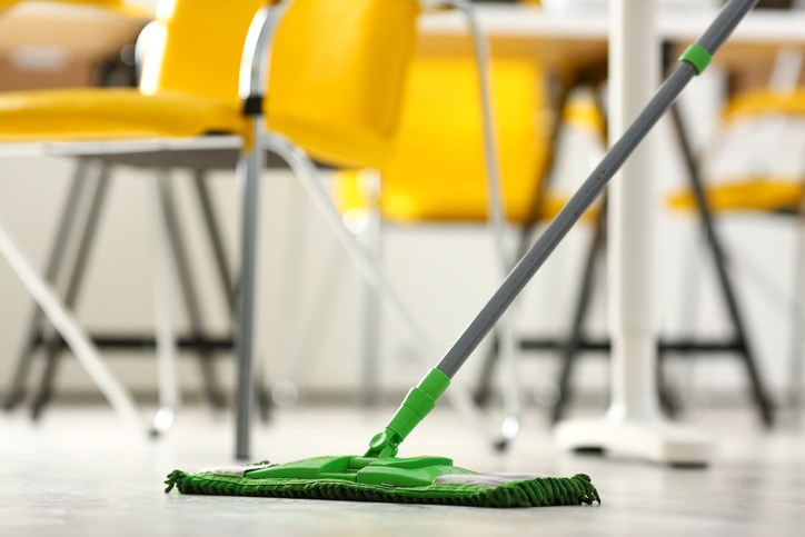 Custodian cleans a school floor.