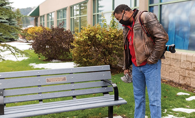 Former Citizen photographer and pressman Chuck Nisbett checks out one of the two benches at the entrance to CN Centre in memory of noted Citizen photographer Dave Mah.