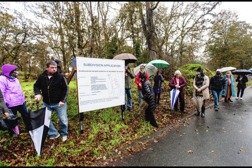 Area residents at the site of a proposed subdivision on Milner Avenue last week. Many are unhappy at the prospect of losing Garry oaks on the largely undeveloped property. DARREN STONE, TIMES COLONIST