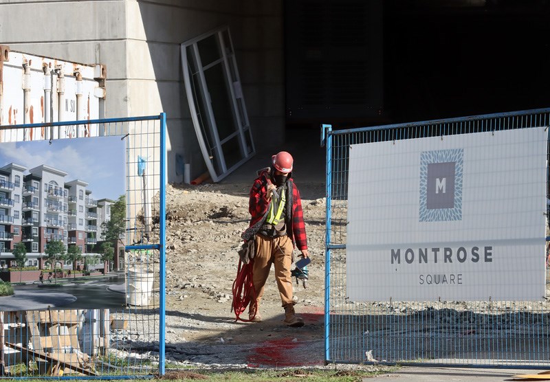 Construction worker outside the Montrose Square condo development in Port Coquitlam. At least six people have tested positive for COVID-19 at the site.