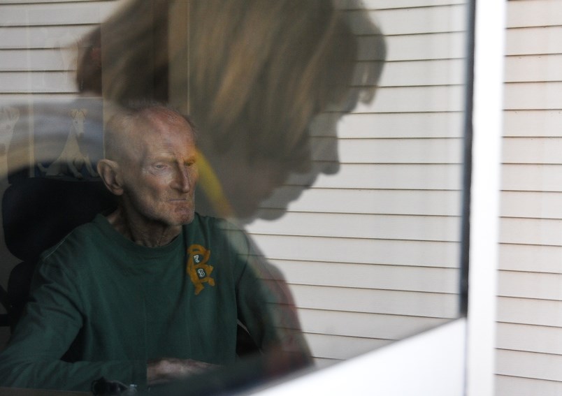 FILE - Brigitte Beurmann waves to her husband Bernie, who suffers from vascular dementia and lives u