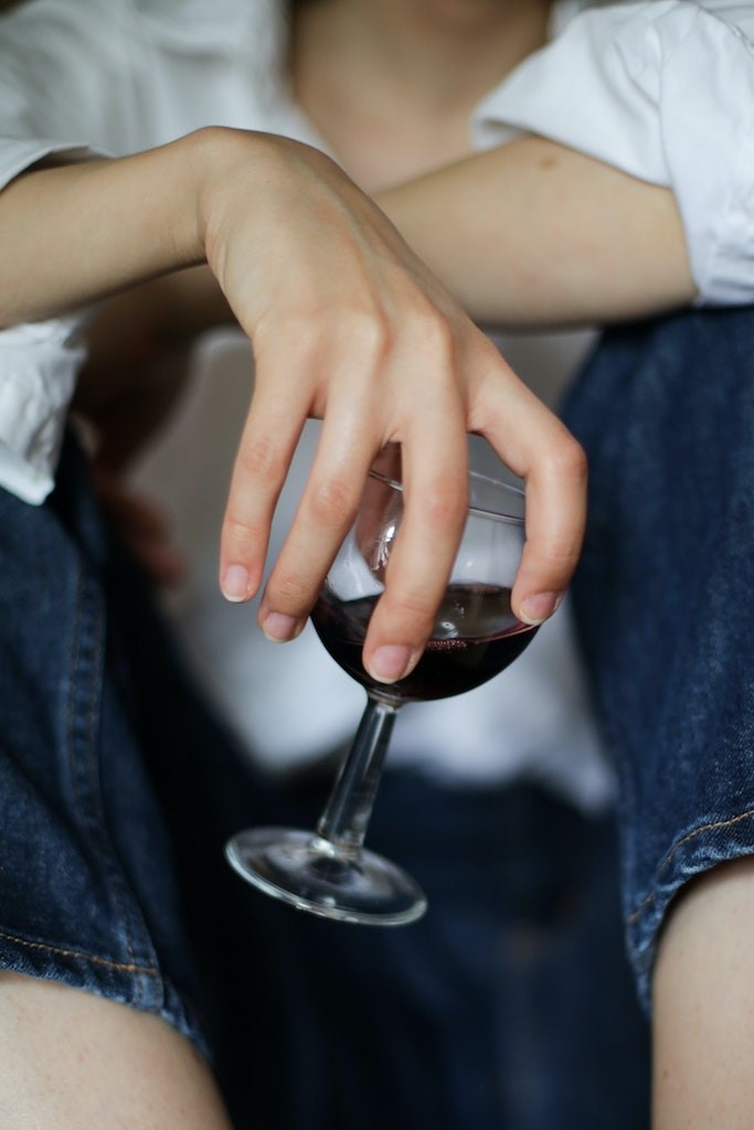 Person holding a glass of wine