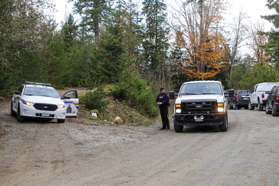 Police were in the bush near Whiskey Creek on Monday, Nov. 2, 2020, a day after three people were found dead on a logging road. ADRIAN LAM, TIMES COLONIST