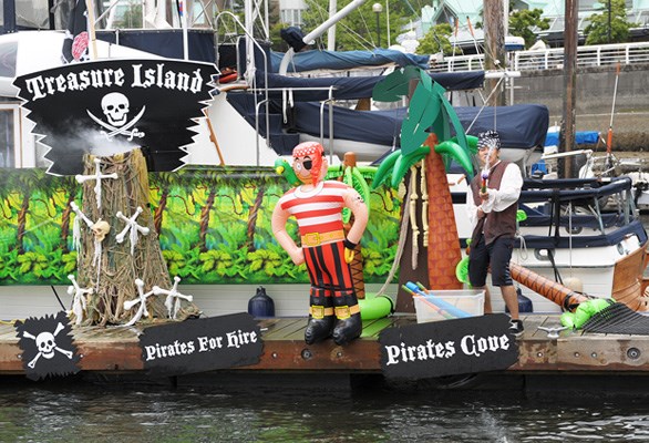 A Treasure Island pirate takes aim at the passing pirate ships - 21 in total
volunteered time and fuel for this event - in False Creek during the 14th
annual Variety Boat for Hope Saturday, June 8, 2013.