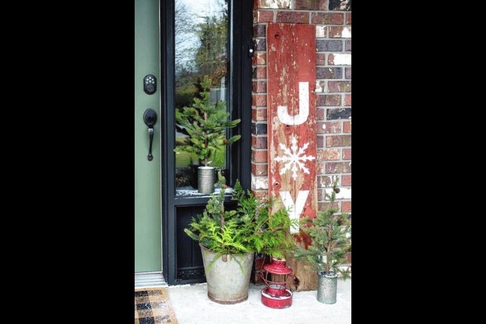 Create a warm welcome at your front door with homemade signs and vintage collections. The door is Fusion Mineral Paint in Bayberry.