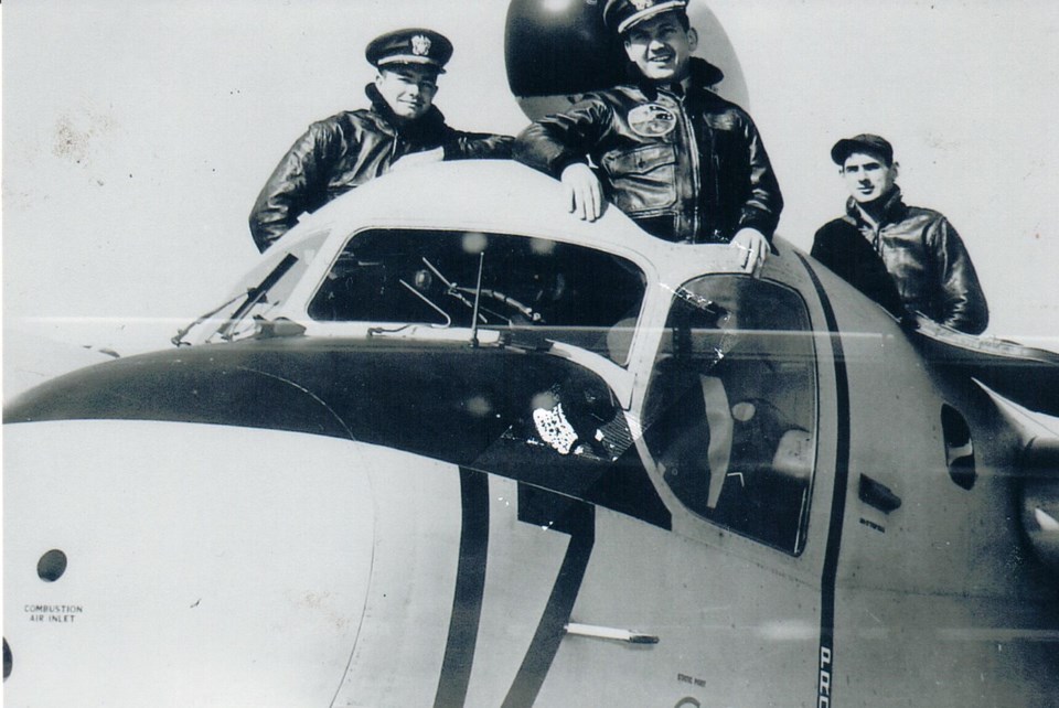 Three men in the cockpit of a plane