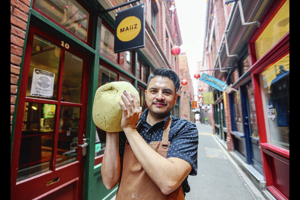 Israel Alvarez, with Willow Rode, right, and Jenna Pollack, works on a large ball of dough at his Maiiz store in Fan Tan Alley in Chinatown. ADRIAN LAM, TIMES COLONIST