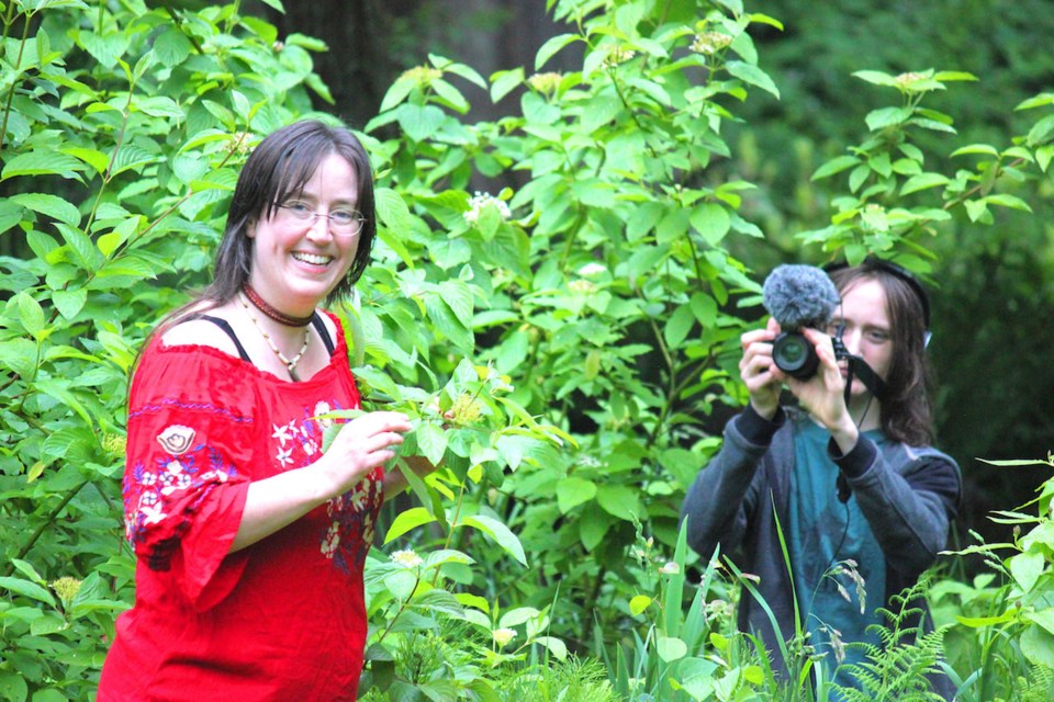 Emily van Lidth de Jeude and Taliesin in a leafy bush