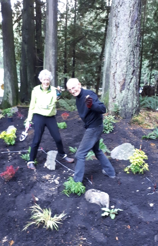 Two people planting in the garden