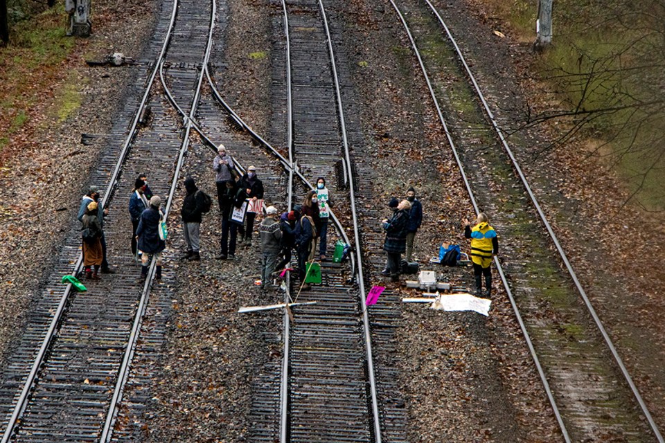 Extinction Rebellion demonstrators occupy a CN railroad in Burnaby, near Highway 1 and North Road, in protest against the Trans Mountain pipeline expansion project, which is slated for construction next to the railroad.