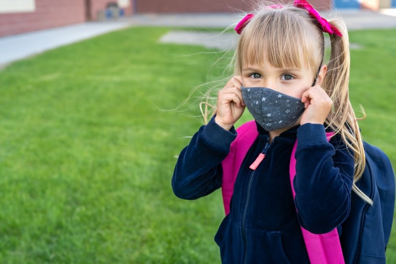 child in mask at school