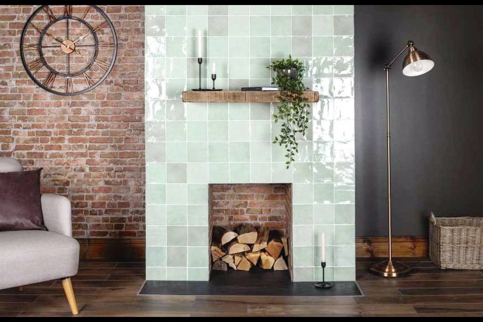 The simplicity and sparkle of the tile fireplace facing creates a striking contrast with the brick wall and firebox.