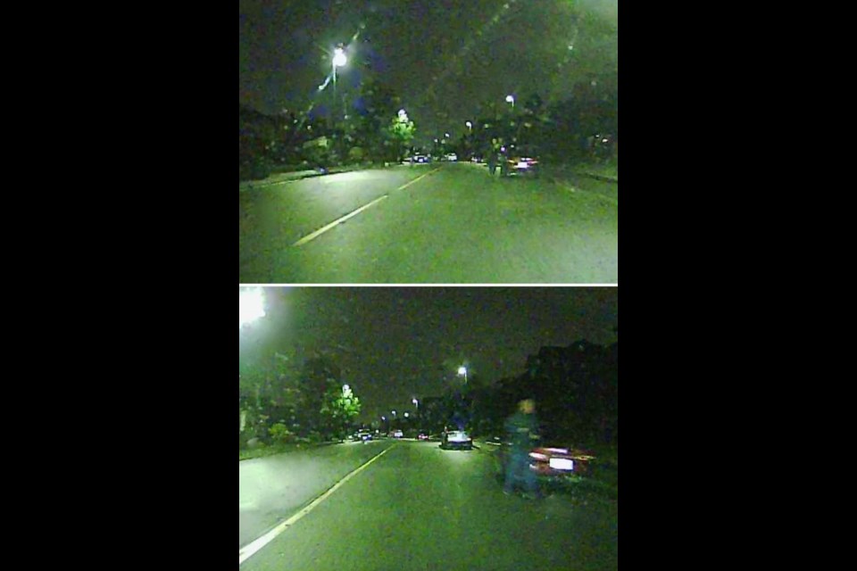 Photos taken from a dash cam showing a man in dark grey clothing running along the street. Coquitlam Mayor Richard Stewart posted these photos on Facebook and expressed concern about people wearing dark clothes at night on city streets.