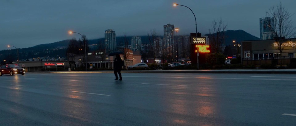 Another example of someone wearing dark clothes on city streets.