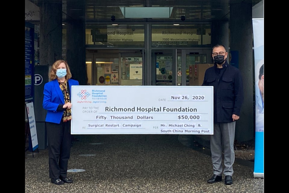 Natalie Meixner (left), president of the Richmond Hospital Foundation, receiving the donation from Michael Ching. Photo submitted