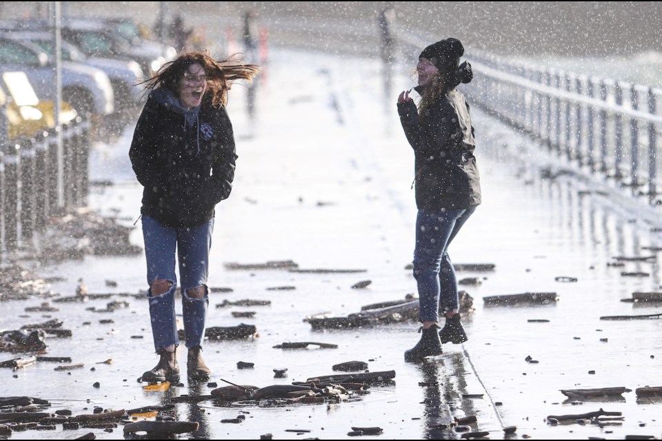 Two women walk along Dallas Road on Monday, Nov. 30, 2020. The City of Victoria closed the roadway and sidewalk between Dock Street and San Jose Avenue later in the day due to public safety concerns as high winds led to large waves and debris in the area. ADRIAN LAM, TIMES COLONIST