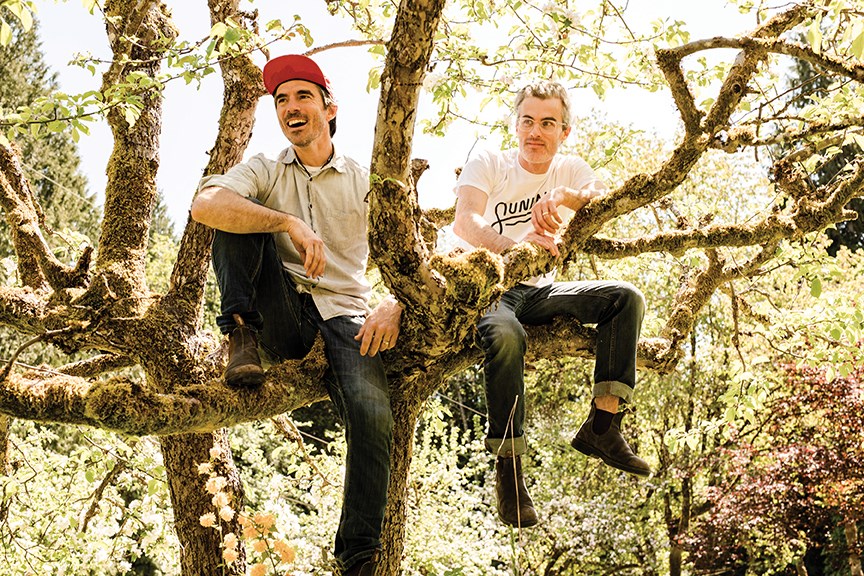 Clinton McDougall and Patrick Connelly hanging out in an apple tree.