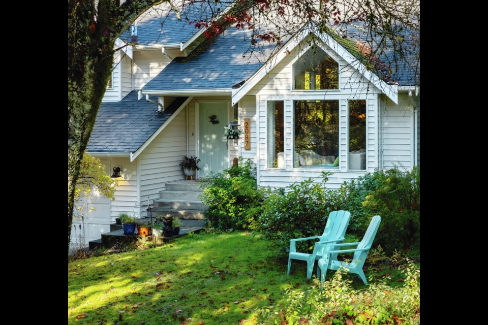 The charming Duncan area home is painted in pale, sandy beach tones with a turquoise door accented by the same colour chairs. Under the south-facing, living room window is a hedge of mock orange that blooms twice a year and billows sweet scent inside the house. DEBRA BRASH, TIMES COLONIST