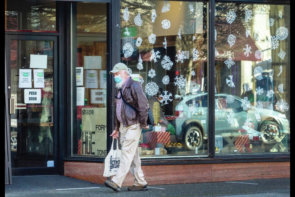 A shopper walks along Government Street in downtown Victoria. [Darren Stone, Times Colonist]