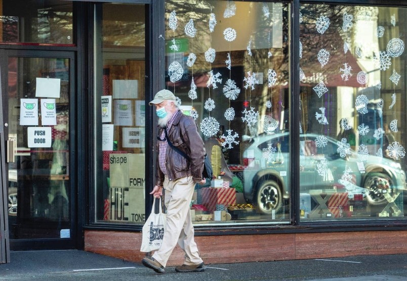 A shopper walks Government Street in downtown Victoria. |Darren Stone, Times Colonist
