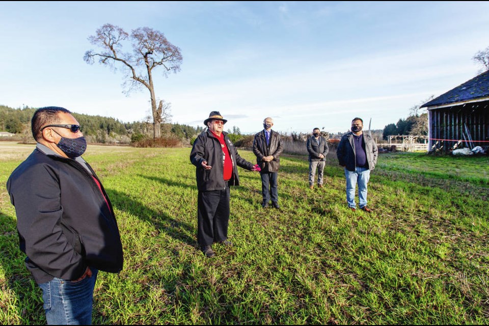 Tsartlip First Nation Coun. Paul Sam, an elder, performs a blessing Thursday at the former Woodwyn Farms as the Tsartlip First Nation takes
possession of the 78-hectare property on the Saanich Peninsula. PHOTOS BY DARREN STONE, TIMES COLONIST