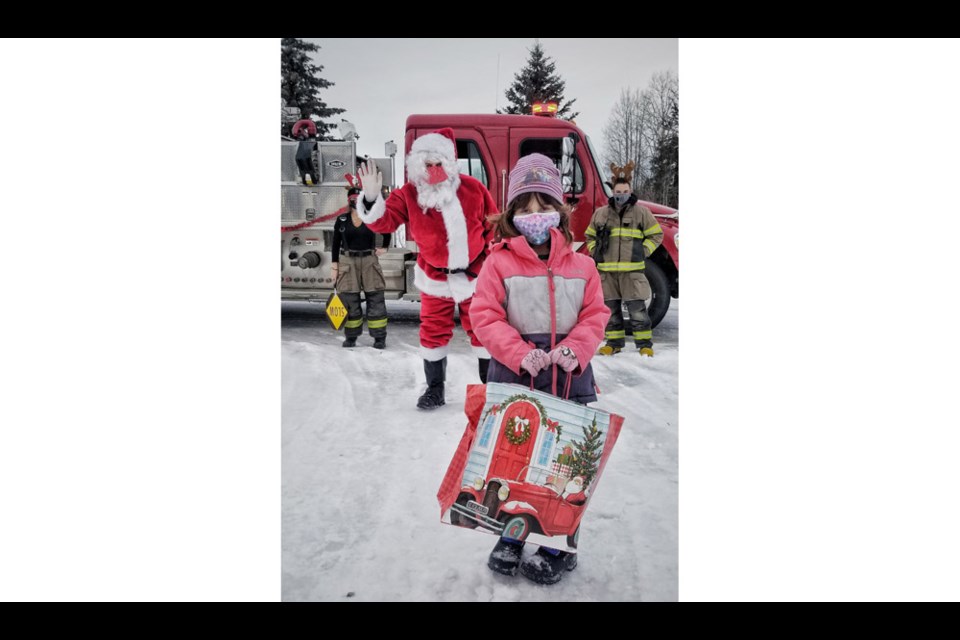 This little girl was happy to receive her goodie bag from Santa as he visited all the good girls and boys in Salmon Valley on Dec. 19 with a little help from the Salmon Valley Community Association and the Volunteer Fire Department.