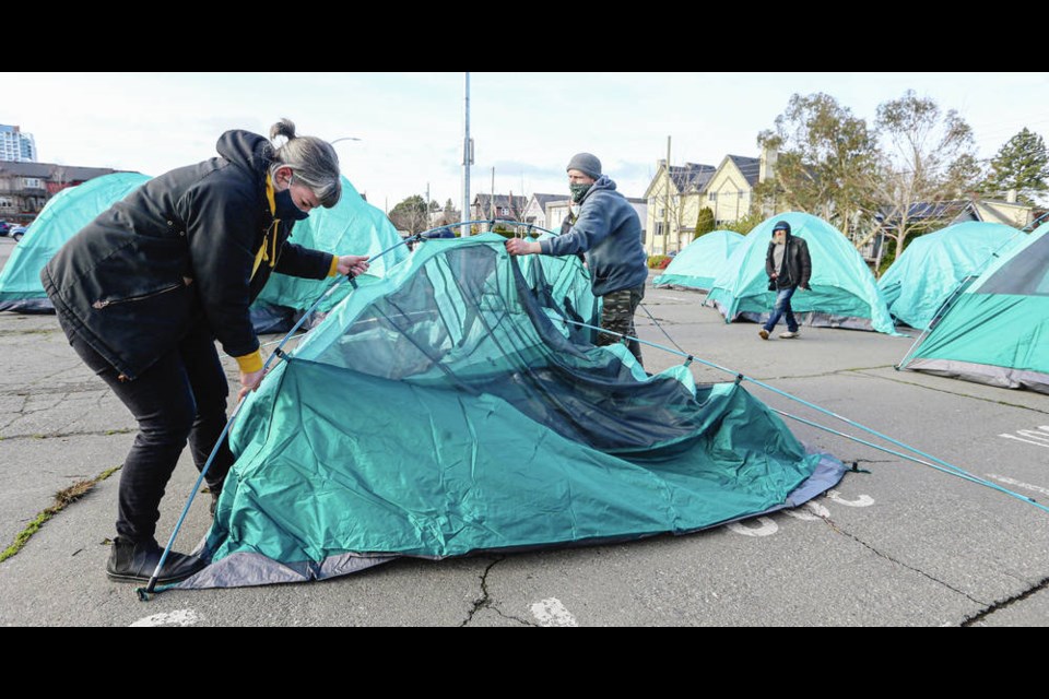 Victoria Coun. Sarah Potts and Jason Chadwick set up tents at the Royal Athletic Park parking lot. ADRIAN LAM, TIMES COLONIST
