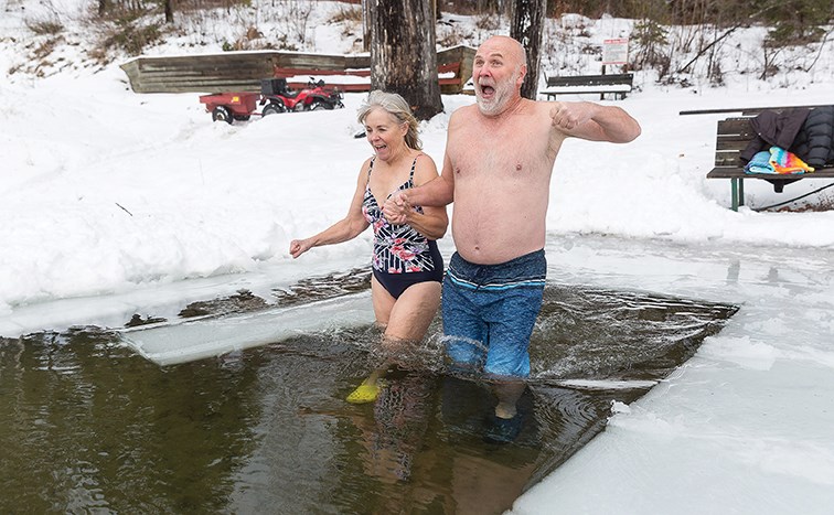 Citizen Photo by James Doyle/Local Journalism Initiative. Carol and Mark Stofer react to the temperature of the icy water of Ness Lake on Friday afternoon during their unofficial Polar Bear Dip fundraiser at Ness Lake Bible Camp. The Stofers raised $20,561 which will be used to help send kids to camp.
