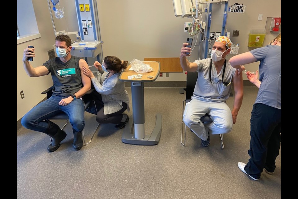 Left to right: Dr. Lukas Brand, ER Physician, receiving one of the first COVID-19 (Moderna) vaccinations today - administered by Ami Drummond, OH&S Nurse; alongside Dr. Erik Coatta, GP Anaesthetist & Infectious Disease Unit Physician - Nurse Administering: Kirsten Bransfield, Inpatient Unit RN.