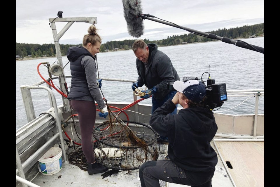 Cast and crew - from left, Scotia Siider, Calvin Siider and Shawn Viens - aboard a fishing boat in a scene from the Victoria-made documentary series Coastal Dwellers, now streaming on Knowledge.ca. Earnest Entertainment