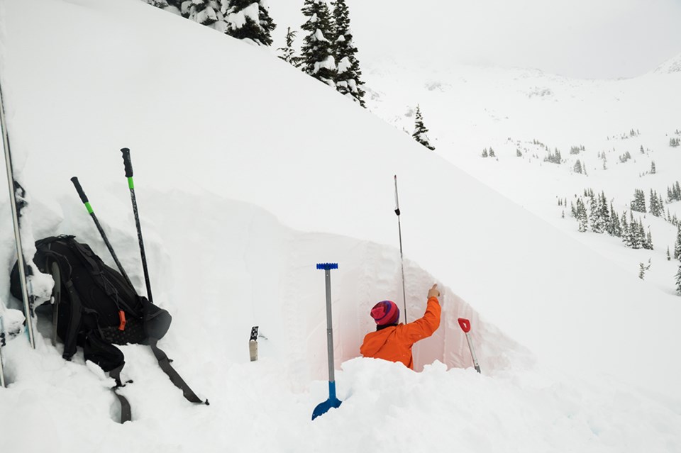 Digging a snow pit to test stability.
