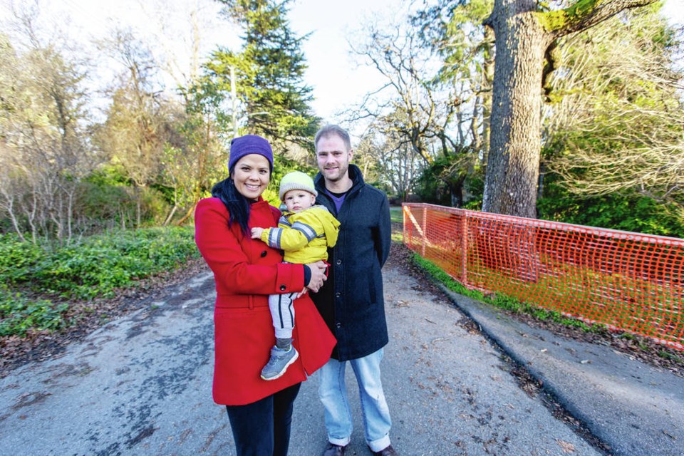 Michelle and Simon Gowing with baby Matthew on their Camosun College-area property, where they hope to build a home. The couple has won approval to put in a stormwater trench rather than having 
to pay $300,000 for a storm drain to be installed along the road. DARREN STONE, TIMES COLONIST