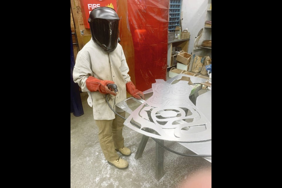 Pyper Phillips cuts a metal “dress” sculpture inspired by a design by First Nations artist Karver Everson. EDWARD MILNE COMMUNITY SCHOOL
