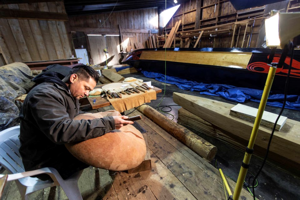 Coast Salish artist Luke Marston works on a moon mask in his workshop on Saturday, Jan. 23, 2021. DARREN STONE, TIMES COLONIST