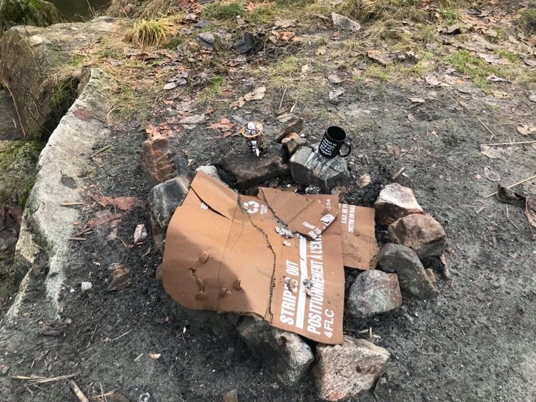 Mugs and wet cardboard left behind at a make-shift campfire in the Squamish Valley.