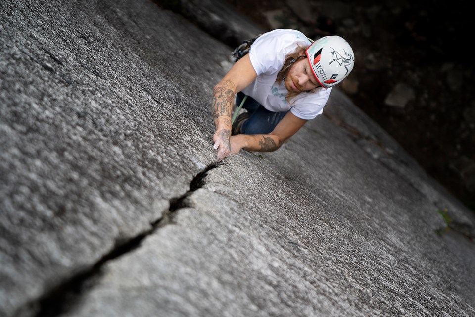 Harvey Writght climbing Arrowroot-Siy’ám’ at the Smánit-Stawamus-Chief. Wright is featured in Crux: The Climb Towards Mental Health documentary.