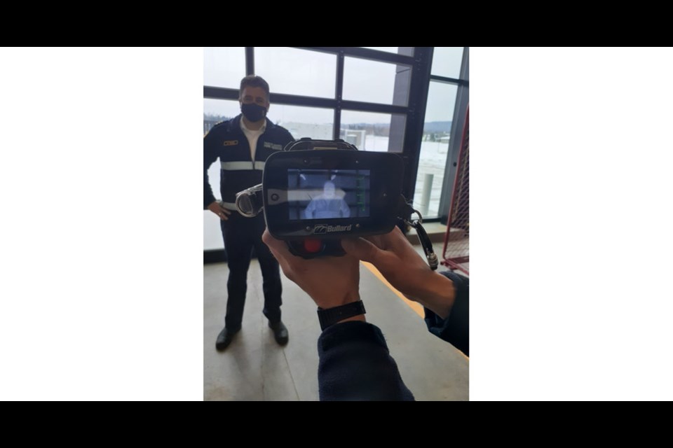 Assistant Fire Chief Dan Pears poses in front of a thermal imaging camera, one of the latest pieces of equipment used in fighting fire.