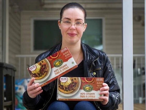 Jenna Roman with Nature's Path maple cinnamon waffle boxes outside her home in Surrey. Jenna is trying to buy up all the Nature's Path cinnamon waffles she can find or buy the recipe from Nature's Path. The company has discontinued making the waffles and this is the only solid food her son Jerico will eat. ARLEN REDEKOP, PNG