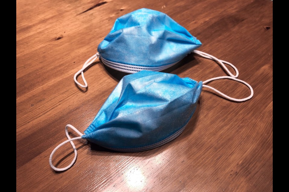 Disposable medical masks that have been knotted and had their sides tucked to make them fit tighter. See the how-to video below.