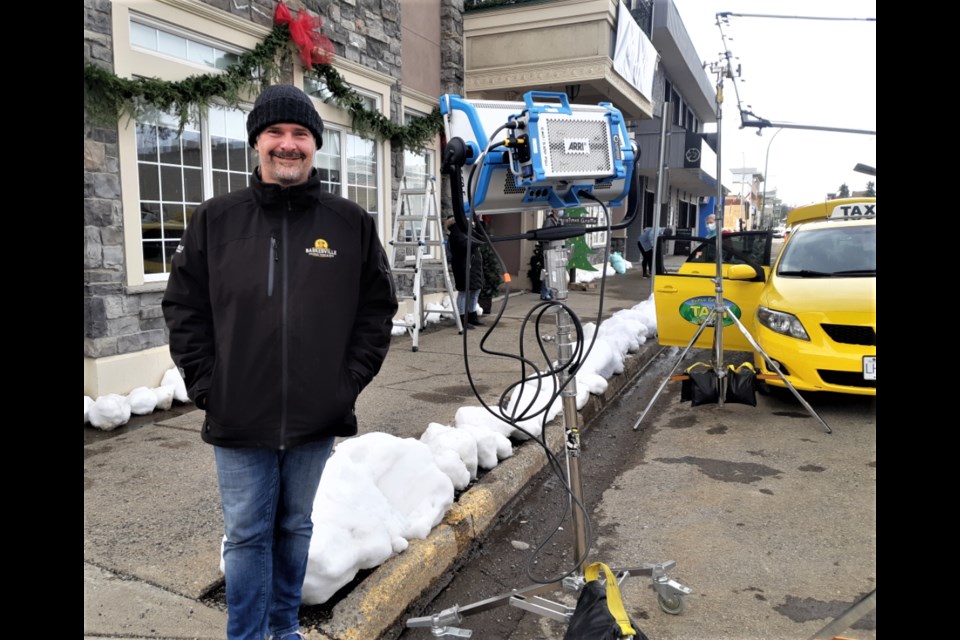 A Great North Christmas director James Douglas gets ready to shoot a scene for the movie Saturday in front of the Twisted Cork restaurant on Fifth Avenue. Filming will continue this week at various city locations and will wrap up on Saturday.