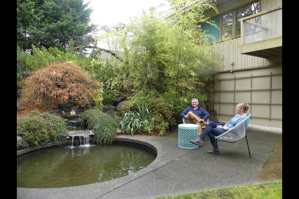 The couple enjoy a quiet moment by the pool created by landscape architect Clive Justice, who was also responsible for the UBC Botanical Garden.