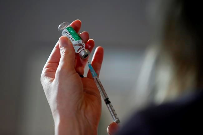 Dr. Joss Reimer, medical lead of the Manitoba Vaccine Implementation Task Force, draws a dose of the AstraZeneca COVID-19 vaccine at a clinic in Winnipeg, Friday, March 19, 2021. THE CANADIAN PRESS/John Woods
