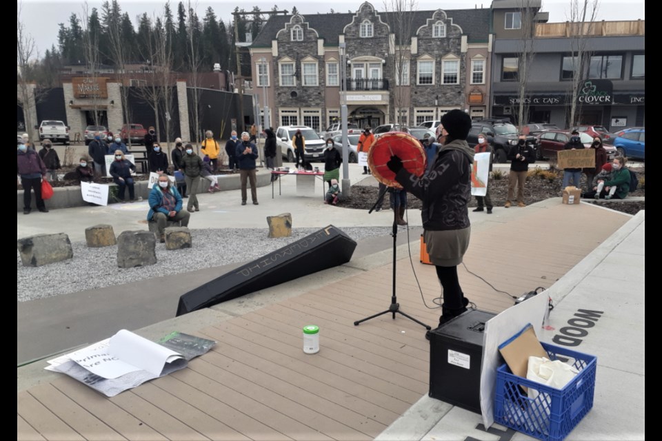 Kym Gouchie sings to the crowd during the Rebellion of the Forests protest in front of the Wood Innovation Centre Friday afternoon.