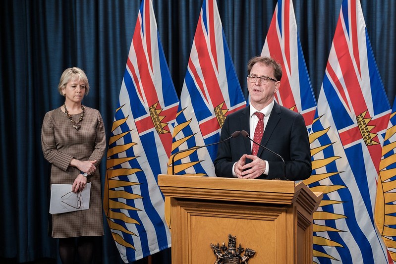 Health Minister Adrian Dix speaks to media as provincial health officer Bonnie Henry looks on
