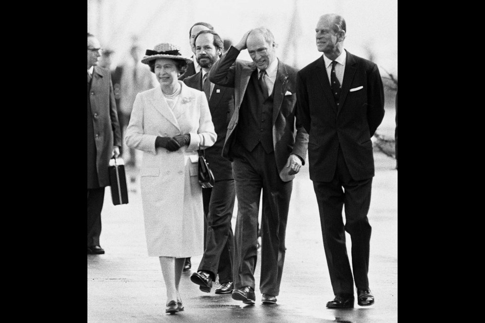 The Queen, left to right, Prime Minister Pierre Trudeau and Prince Philip walk along the pier after arriving in Vancouver on March 9, 1983, aboard the Royal yacht Britannia from Victoria. Prince Philip, the Queen's husband of more than 70 years, passed away at Windsor Castle on April 9. THE CANADIAN PRESS/Nick Didlick