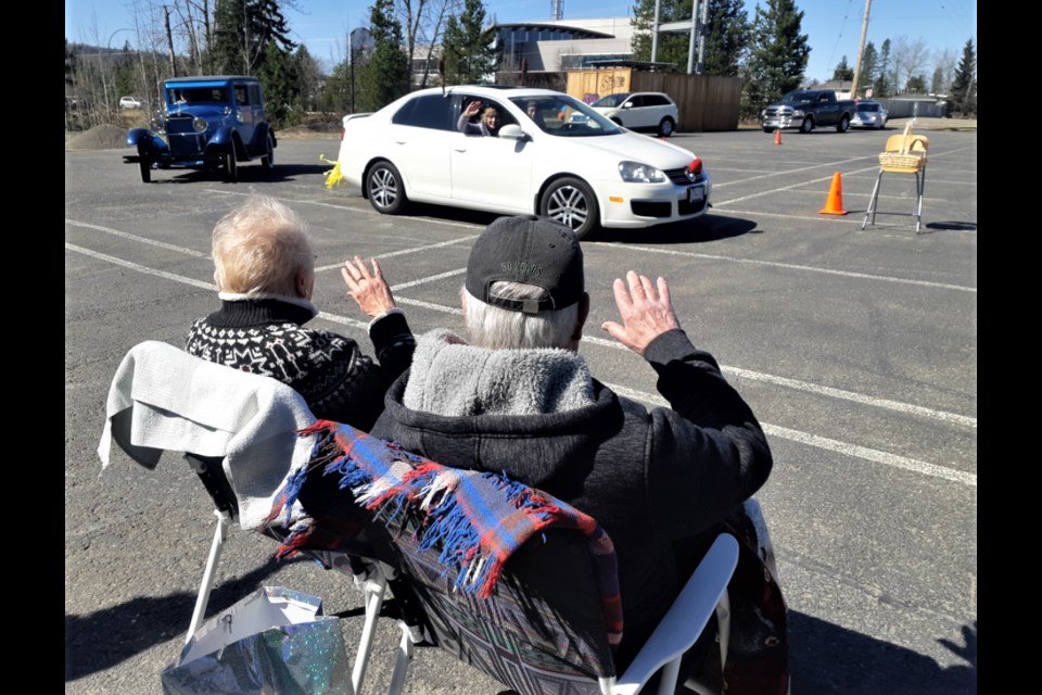 Russella and Ben Klassen wave to a long line of well-wishers who drove into the parking lot at Lakewood Alliance Church Sunday afternoon for a farewell salute. The Klassens owned and operated Homesteader Meats in the city for 36 years.