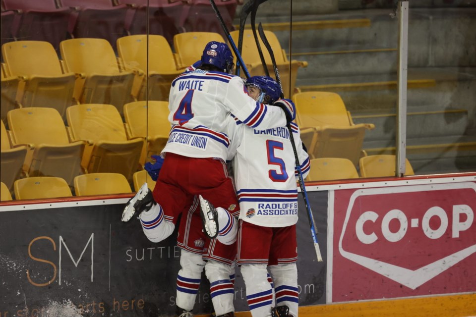 Defenceman Mason Waite jumps into a pile of Spruce Kings celebrating a goal during their game Saturday against the Chilliwack Chiefs in Chilliwack. The Kings won their third straight game, defeating the Chiefs 5-2.