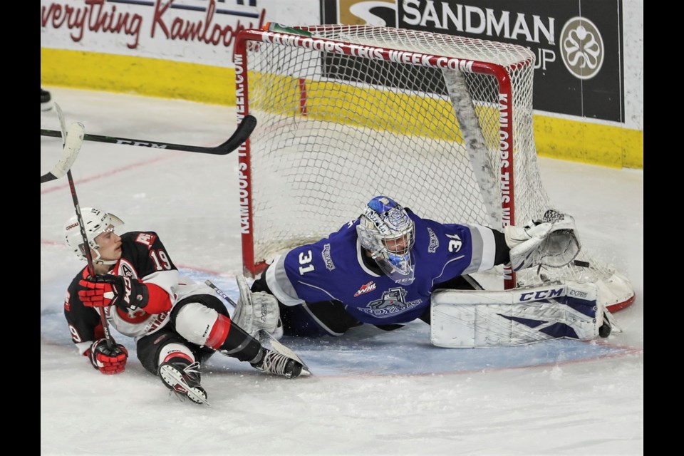 Victoria Royals goalie Adam Evanoff does the splits to make a save after Cougars centre Ethan Browne (prone on the ice) and Kyren Gronick combined for a scoring chance during WHL action Monday in the Kamloops hub at Sandman Centre. The Cougars skated to a 4-1 victory.