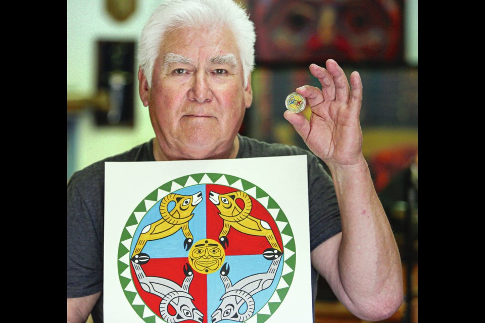 Kwakiutl artist Richard Hunt with the painted image and gold coin he designed for the Canadian Mint, at his home studio. The pure-gold $200 coin, called Ramming Bighorn Sheep, is being sold for $4,200. ADRIAN LAM, TIMES COLONIST